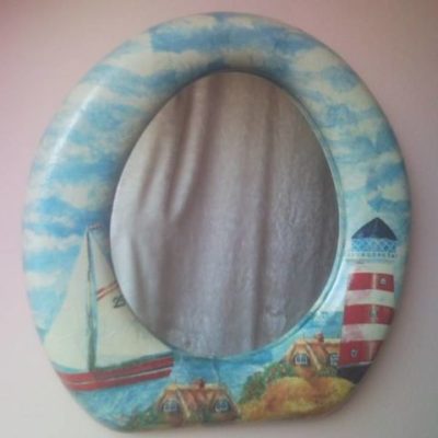 Upcycled toilet seat wall mirror with decoupage lighthouse and sailing boat