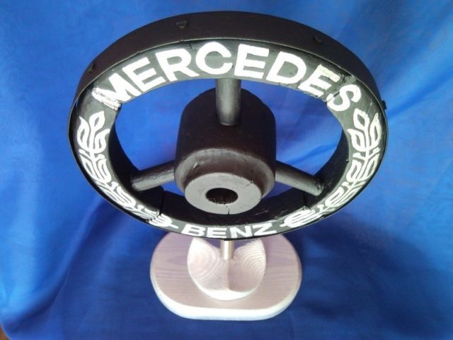 Mercedes Benz car brand emblem, sign, logo from old wooden wheel