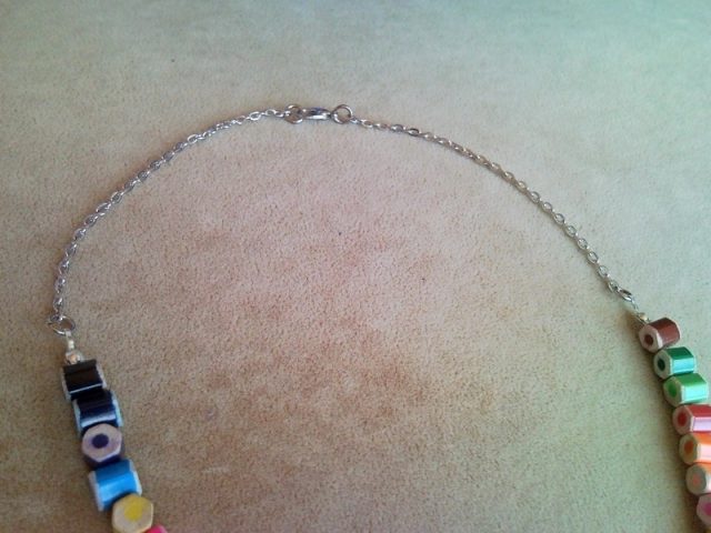 Rainbow style colored pencil necklace on silver colored chains